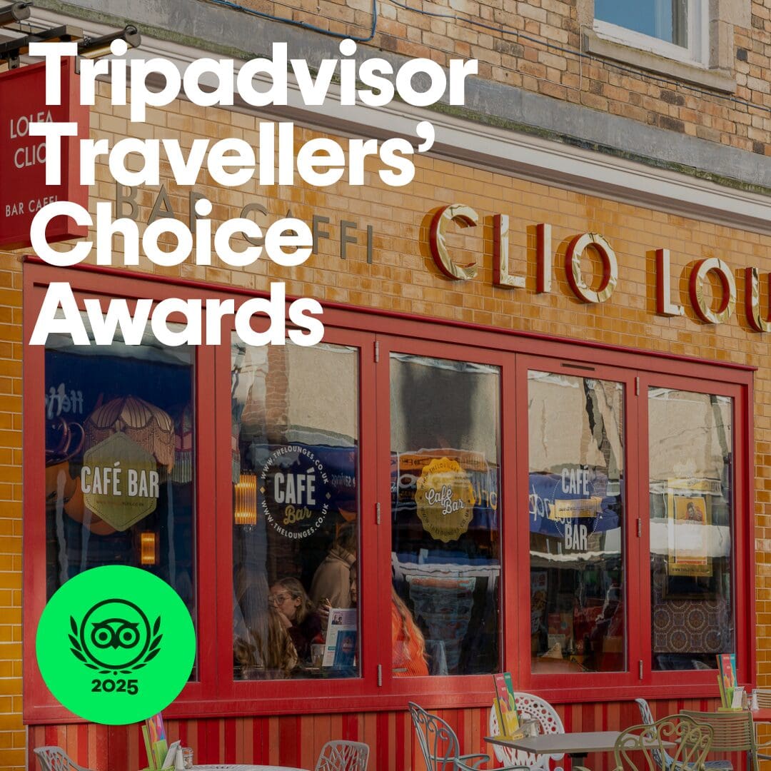 People sit at tables outside a café called Clio Lou on a sunny day. Large white text reads “Tripadvisor Travellers’ Choice Awards.” A green Tripadvisor 2025 badge is in the lower left corner.